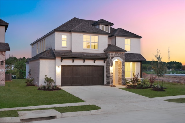 view of front of home featuring a garage, central AC unit, and a lawn