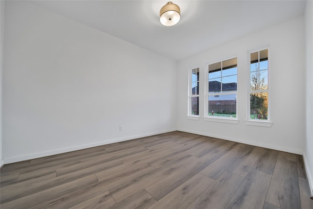 unfurnished room featuring hardwood / wood-style flooring