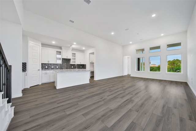 unfurnished living room with dark wood-type flooring and sink