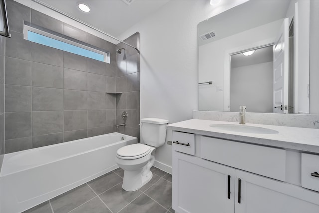 full bathroom with toilet, vanity, tiled shower / bath, and tile patterned flooring