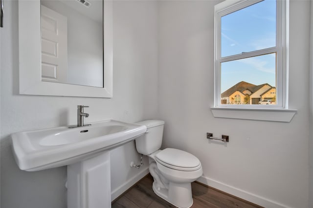 bathroom featuring hardwood / wood-style flooring and toilet