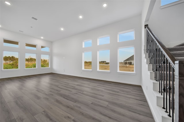 unfurnished living room featuring light wood-type flooring and a healthy amount of sunlight