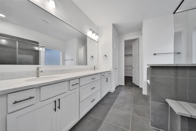 bathroom with tile patterned flooring and vanity