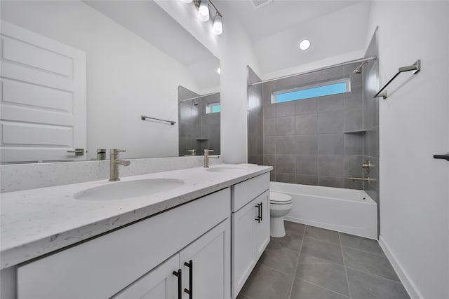 full bathroom with tile patterned flooring, vanity, toilet, and tiled shower / bath