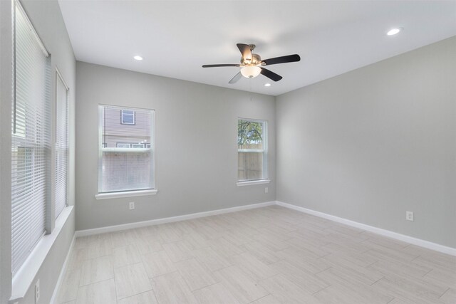 spare room with ceiling fan and light tile patterned flooring