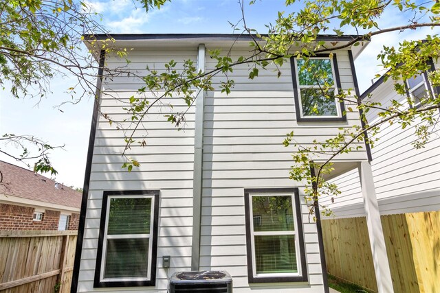 view of side of home with central AC