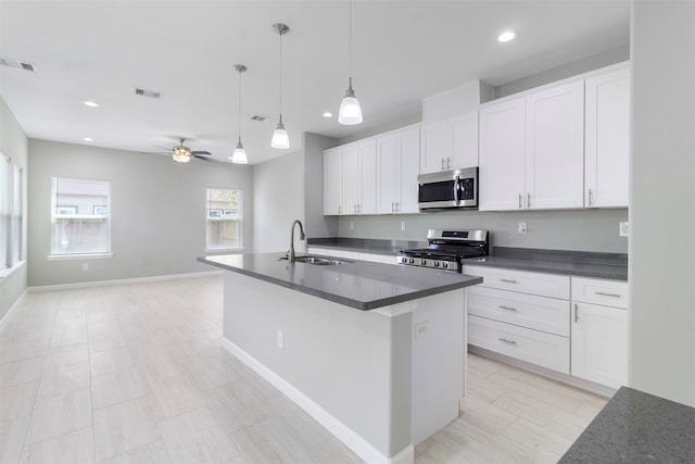 kitchen featuring ceiling fan, white cabinetry, sink, and appliances with stainless steel finishes