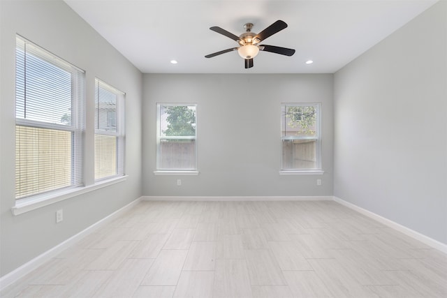 tiled spare room featuring ceiling fan