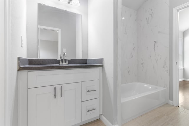 bathroom with shower / bathtub combination, tile patterned flooring, and vanity