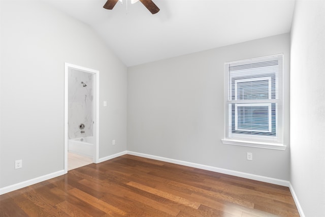 empty room featuring ceiling fan, hardwood / wood-style flooring, and lofted ceiling