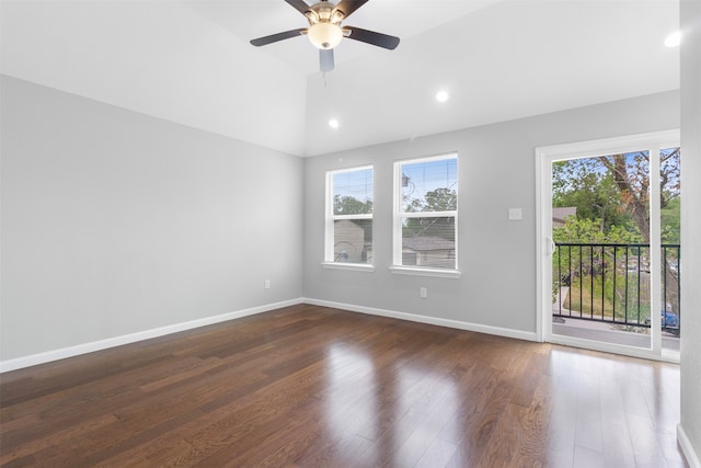 empty room featuring ceiling fan, vaulted ceiling, wood-type flooring, and plenty of natural light