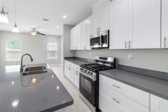 kitchen featuring sink, ceiling fan, white cabinetry, and stainless steel appliances