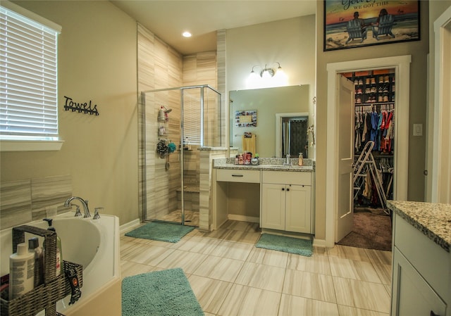 bathroom featuring tile patterned floors, vanity, and independent shower and bath