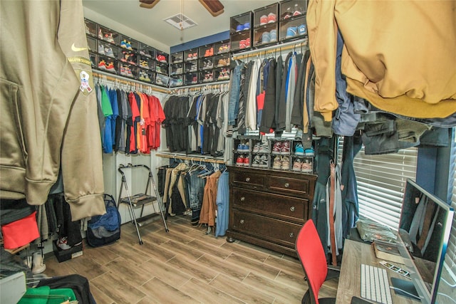 spacious closet with ceiling fan and light hardwood / wood-style floors