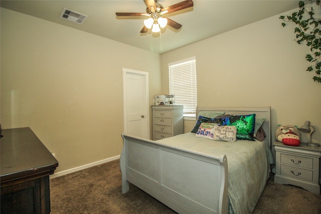 bedroom with ceiling fan and dark colored carpet