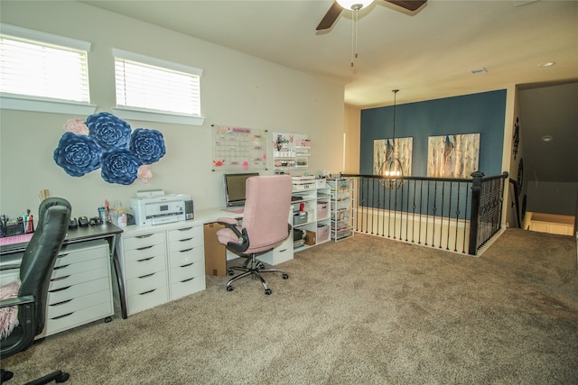 carpeted office with ceiling fan with notable chandelier