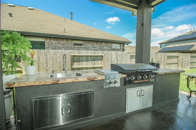 view of patio / terrace featuring area for grilling, sink, and grilling area