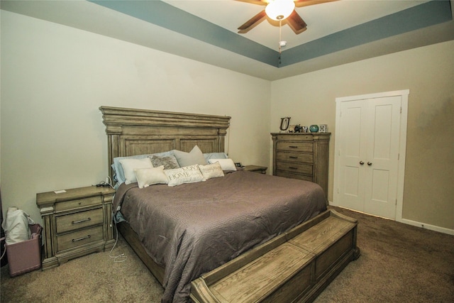 carpeted bedroom with ceiling fan and a closet