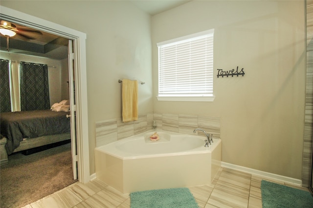 bathroom with tile patterned flooring and a bath