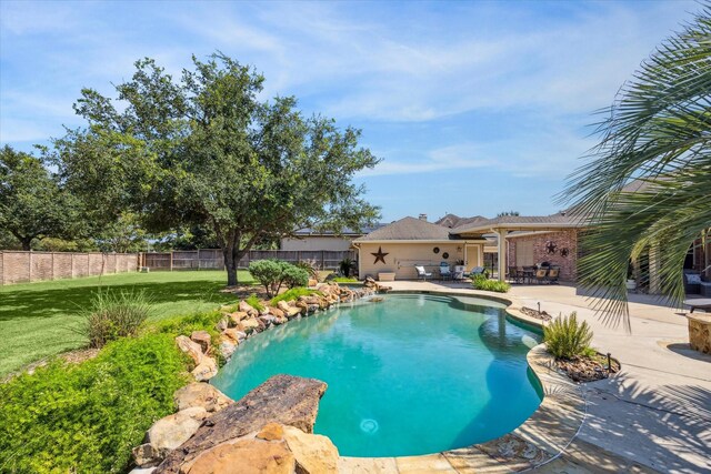 view of pool with a patio area and a lawn