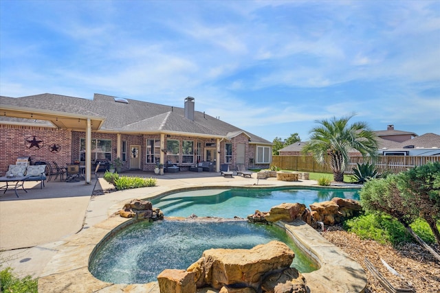 view of pool with a patio area and an in ground hot tub