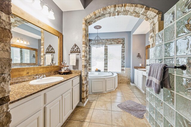 bathroom featuring tile patterned flooring, a bathtub, and vanity