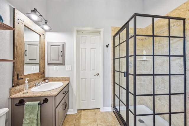 bathroom with tile patterned flooring, toilet, vanity, and a shower with shower door