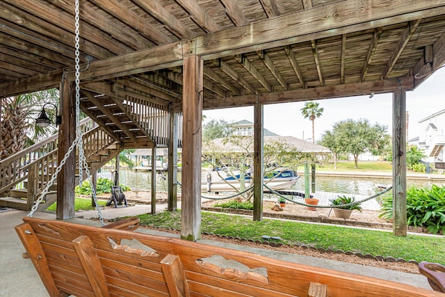 view of patio / terrace with a water view and a dock