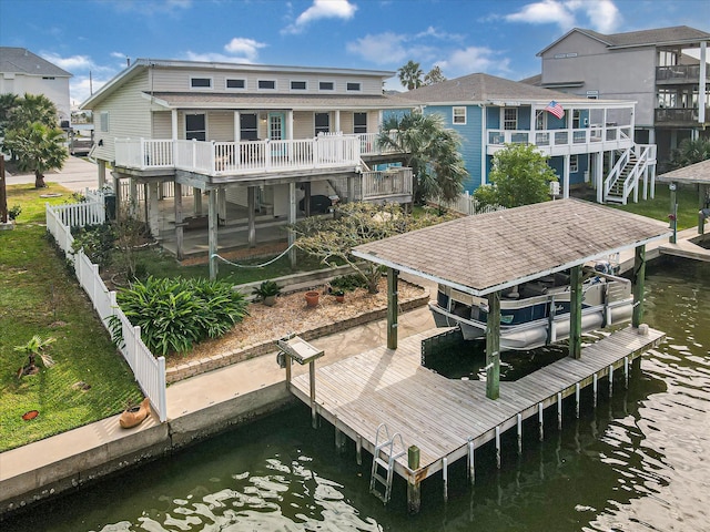 dock area with a water view and a balcony