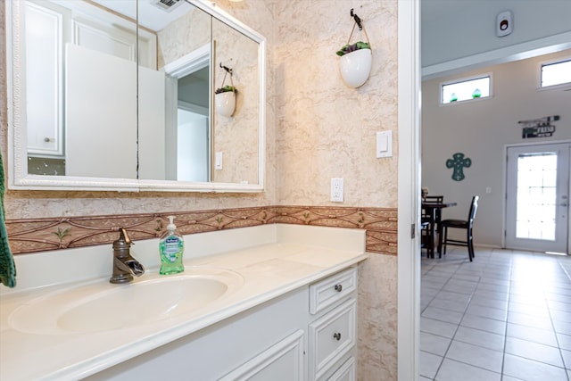 bathroom featuring tile patterned floors, vanity, and a healthy amount of sunlight