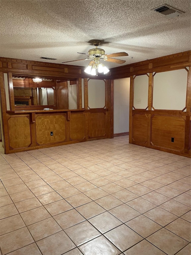 spare room with visible vents, a textured ceiling, and ceiling fan