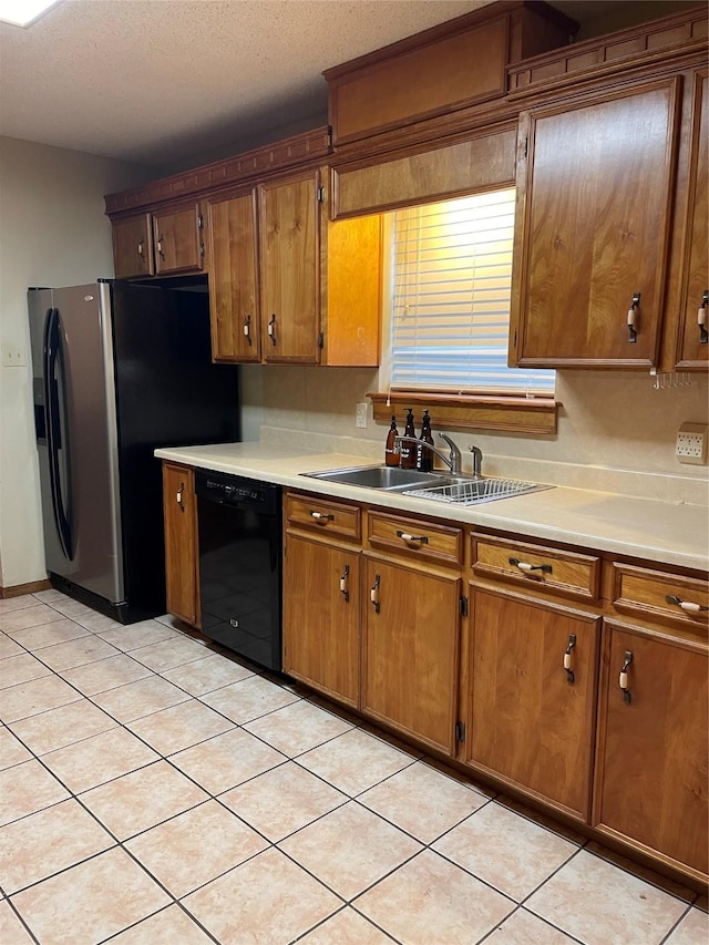 kitchen with light countertops, brown cabinets, dishwasher, and a sink
