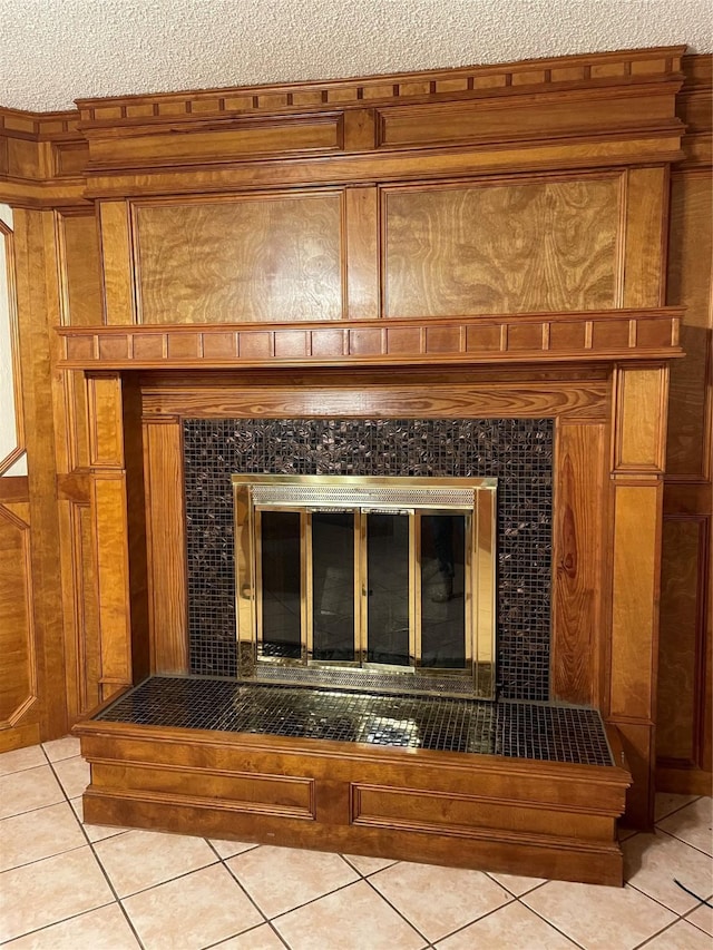 details with a tiled fireplace and wood walls