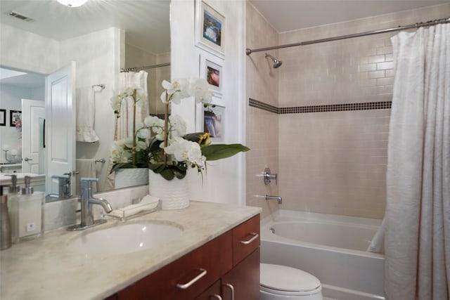 full bathroom with vanity, toilet, and shower / bath combination with curtain