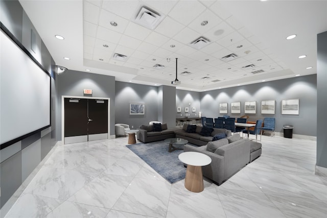 cinema with a raised ceiling and a paneled ceiling