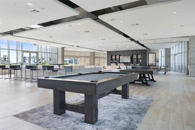 rec room with light wood-type flooring, a wall of windows, and billiards