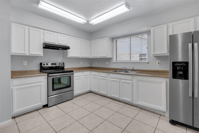 kitchen featuring white cabinetry, sink, stainless steel appliances, a textured ceiling, and light tile patterned floors