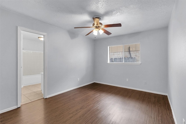 spare room with a textured ceiling, hardwood / wood-style flooring, and ceiling fan