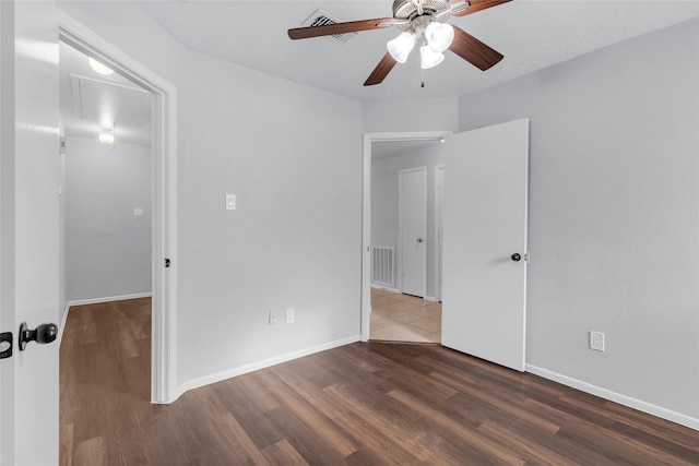 empty room featuring ceiling fan and dark hardwood / wood-style flooring