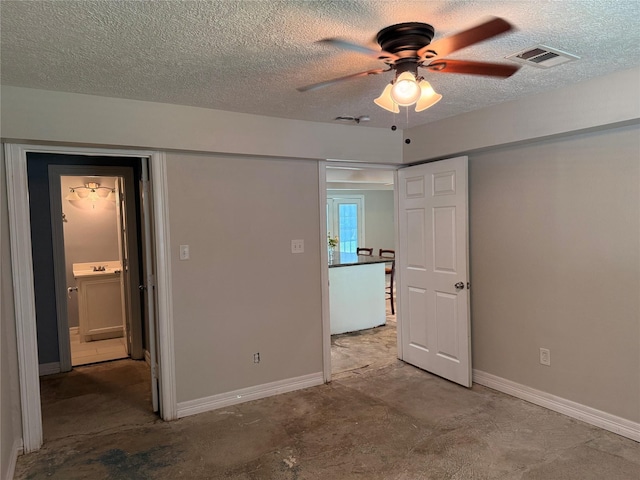 712 S Blackwell St, La Porte, TX 77571 - unfurnished bedroom with a textured ceiling, baseboards, and a ceiling fan