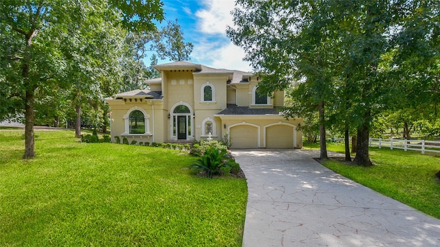 mediterranean / spanish home with a garage and a front yard