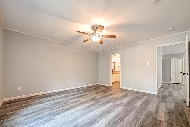 unfurnished room with ceiling fan, wood-type flooring, and ornamental molding