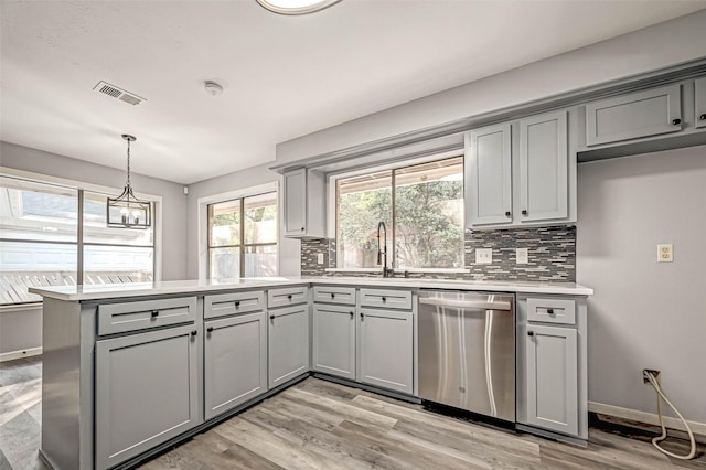 kitchen featuring stainless steel dishwasher, a peninsula, visible vents, and gray cabinetry