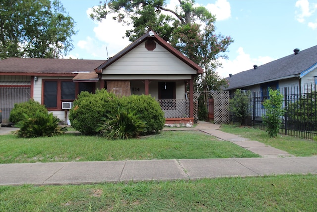 bungalow-style home with a front lawn