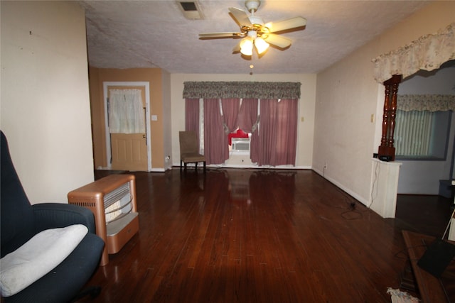 foyer with ceiling fan, dark wood-type flooring, and a textured ceiling