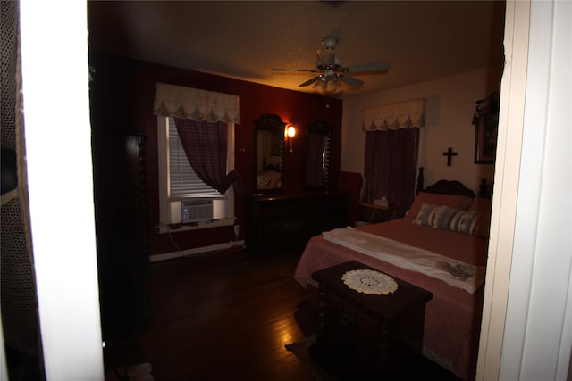 bedroom featuring hardwood / wood-style flooring, cooling unit, and ceiling fan