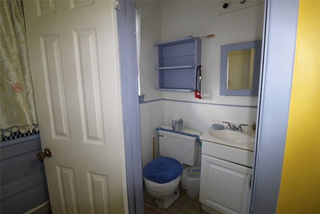 bathroom with tile patterned flooring, toilet, and vanity