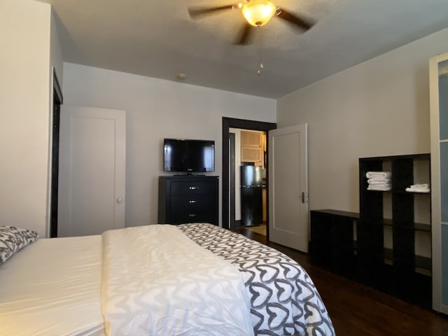 bedroom with ceiling fan and dark wood-type flooring