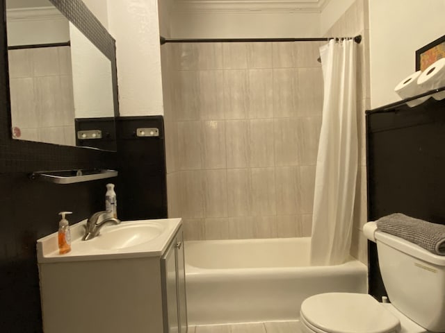 full bathroom featuring ornamental molding, vanity, tile patterned floors, shower / bath combination with curtain, and toilet