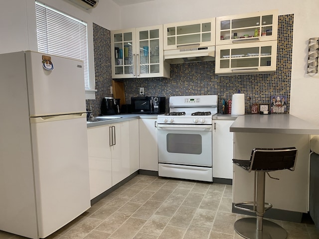 kitchen with premium range hood, white cabinetry, tasteful backsplash, light tile patterned floors, and white appliances